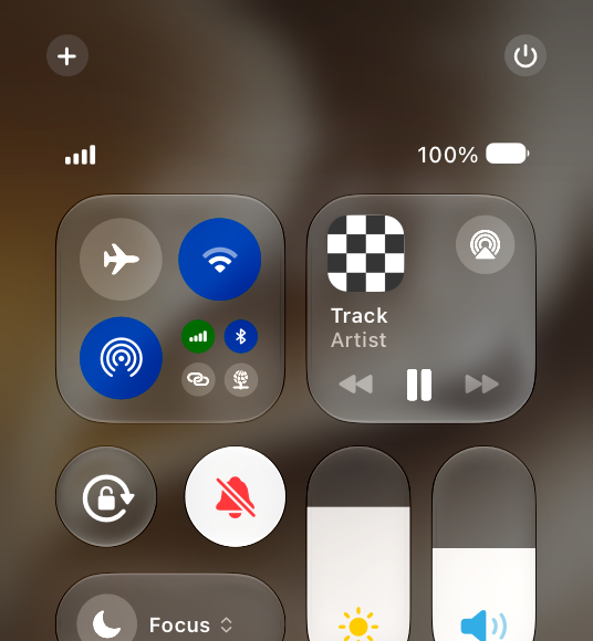 A partial screenshot of Control Center on iPhone, highlighting that the Silent mode control is active, with a symbol of a bell with a line drawn through it and red tint.