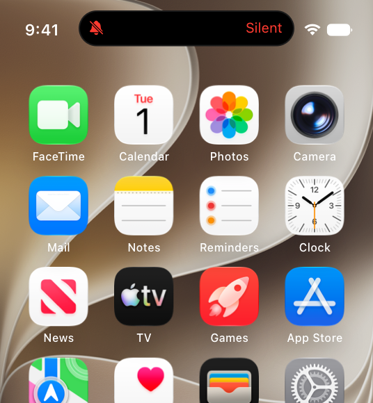 A partial screenshot that displays the Dynamic Island at the top of the Home Screen on iPhone, showing that the Silent mode control is active with a red tinted symbol of a bell with a line drawn through it in the leading area and red tinted text that says Silent in the trailing area.