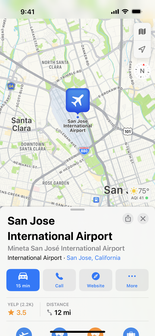 A screenshot of a map on iPhone, displaying the San Jose International airport and the surrounding area. A card in the bottom half of the screen displays information and options, including the airport name and buttons for sharing, closing the card, navigating to the airport, calling the airport, visiting the airport's website, and more.