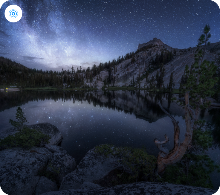 A nighttime photo of an alpine lake with a system-provided Live Photo badge without text in the upper left corner.