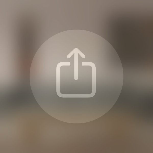 An illustration of a Share button with a translucent background material and a symbol. The symbol uses the tertiary vibrant label color and has muted contrast against the background material.