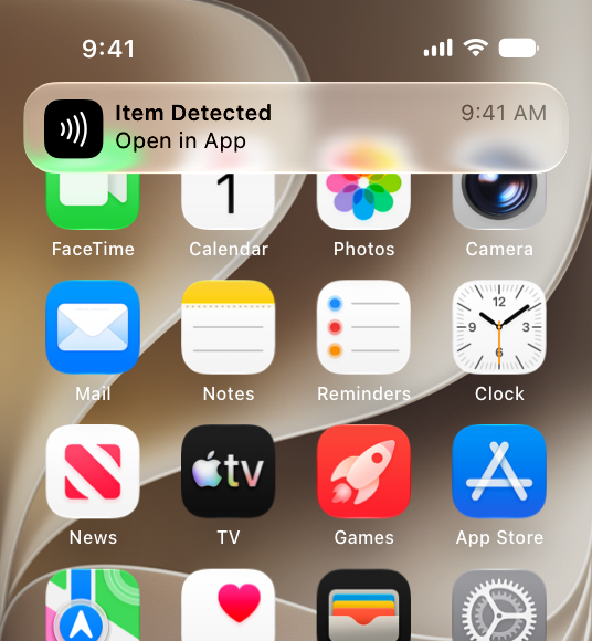 An illustration of a notification banner above the Home screen on iPhone, which offers an opportunity to open a specific app to process NFC tag data detected nearby.