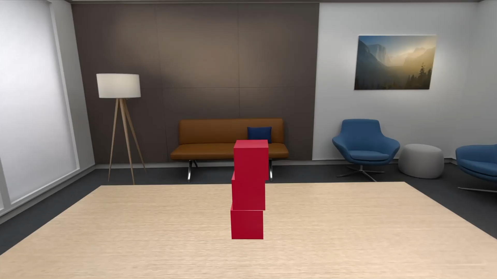 A recording showing a table with a vertical stack of three virtual cubic blocks on it in visionOS. A person moves their hand toward the blocks from right to left, and their extended fingers touch and push aside the center block. The center block falls to the side, and the other block also tumbles onto the tabletop.