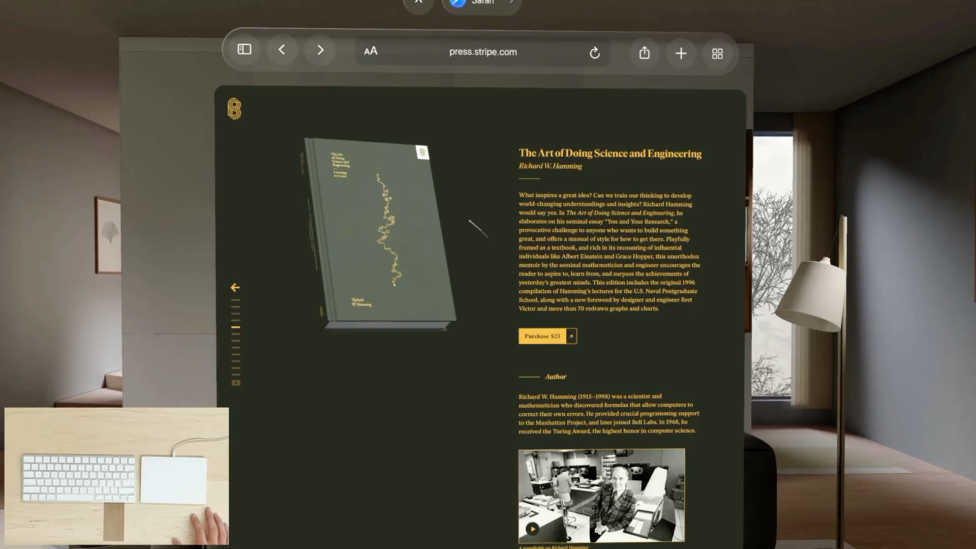 A recording that shows a pointer moving around, highlighting items, and scrolling content within a Safari window in visionOS. A picture-in-picture window is visible in the bottom left corner of the recording. It shows a person's hand operating a trackpad next to a keyboard outside the field of view. The person's gestures on the trackpad correspond to the pointer movements.