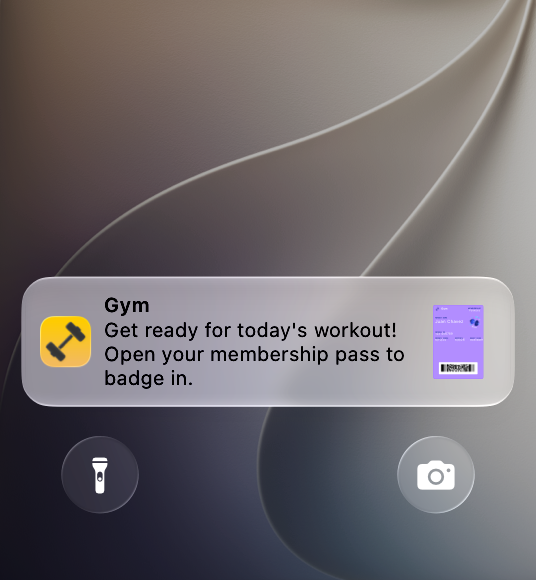 A screenshot of the bottom portion of the Lock Screen on iPhone showing a banner from the Gym app that reads 'Get ready for today's workout! Open your membership pass to badge in.'